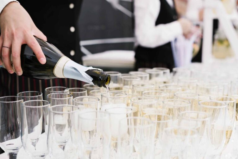 Botella y copas de champan en cocktail de evento corporativo